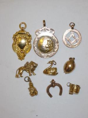 Appraisal: TWO CT GOLD FOBS one moulded with fishermen and seven