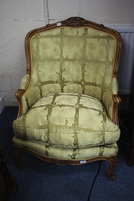 Appraisal: A PAIR OF LOUIS XV STYLE UPHOLSTERED FAUTEUILS with carved