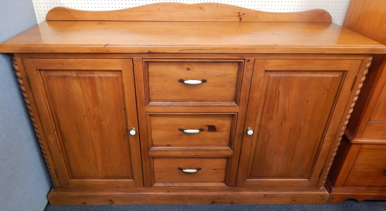 Appraisal: A pine sideboard with a raised back above an arrangement