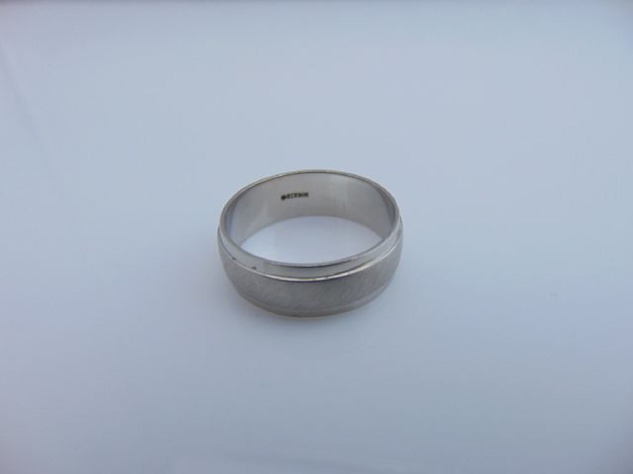 Appraisal: A gentleman's platinum ring stamped the plain polished shank applied