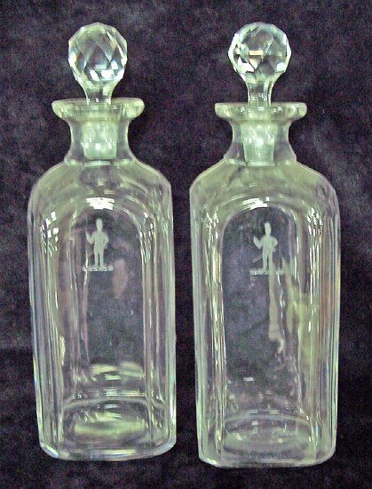 Appraisal: A pair of Georgian plain glass decanters with faceted stoppers