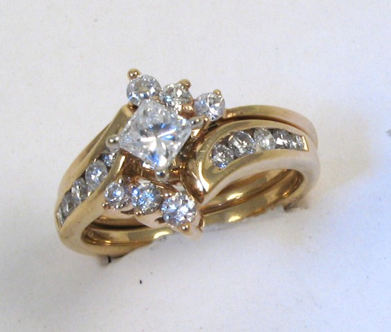 Appraisal: DIAMOND AND FOURTEEN KARAT GOLD WEDDING SET centering a princess-cut