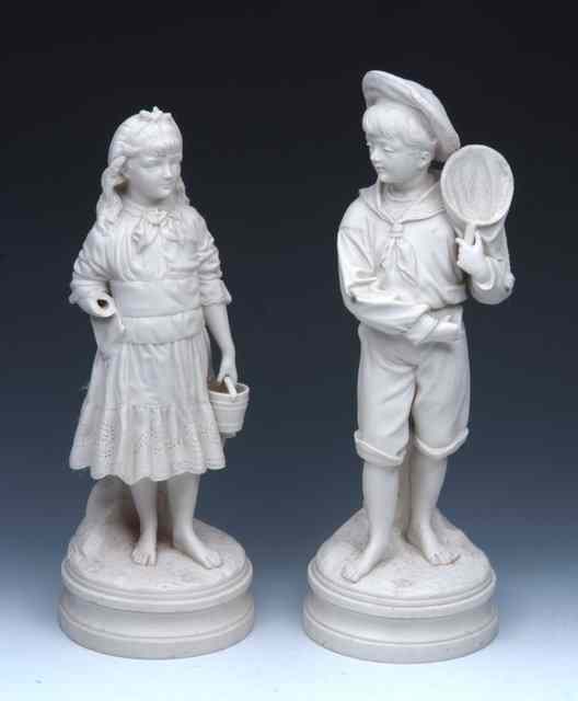 Appraisal: A PAIR OF VICTORIAN PARIAN WARE FIGURES of a boy