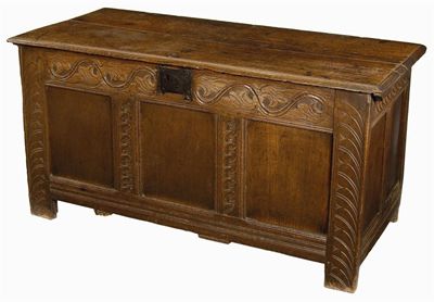 Appraisal: A late th century carved oak chest the boarded top