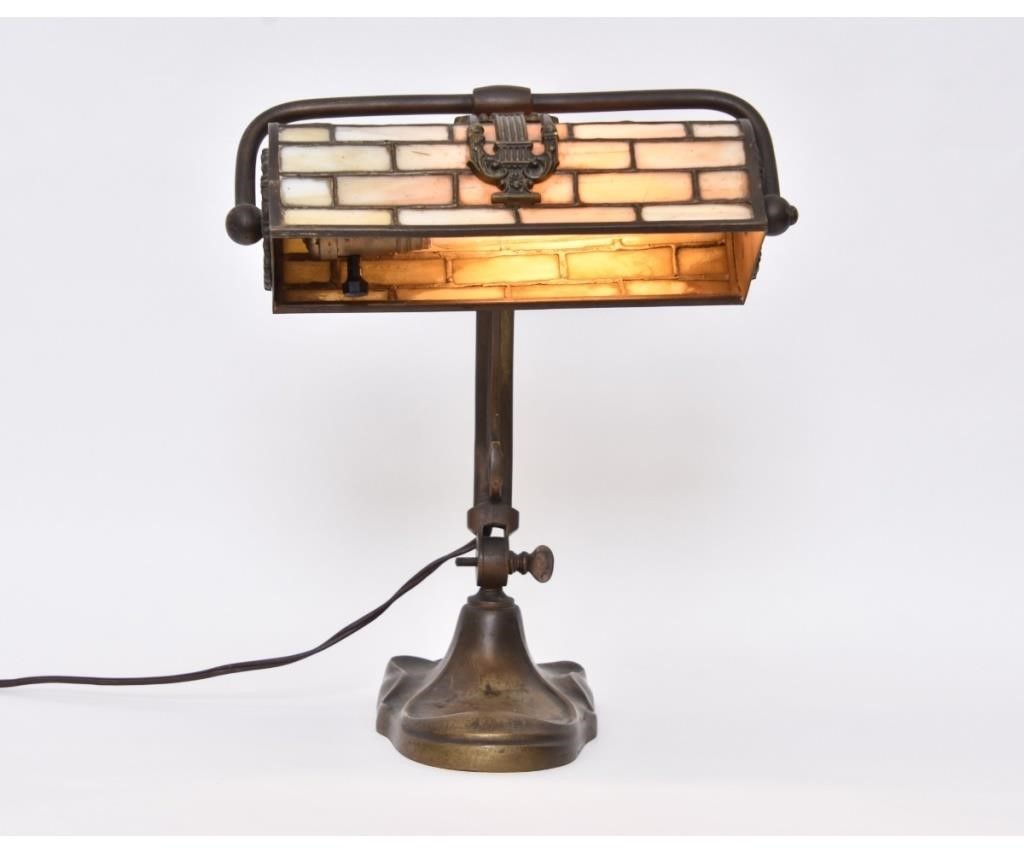 Appraisal: Art Nouveau bronze desk lamp with leaded slag glass shade