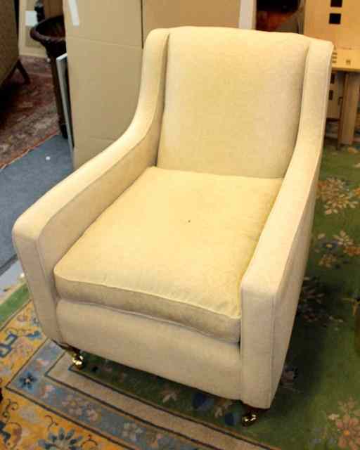 Appraisal: A PAIR OF CONTEMPORARY CREAM UPHOLSTERED ARMCHAIRS standing on square