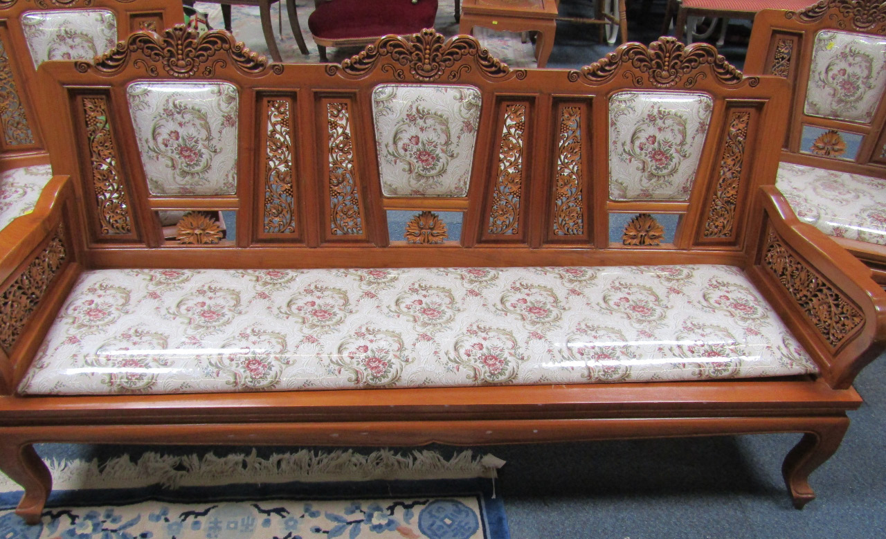 Appraisal: An Indonesian carved hardwood lounge suite comprising two three seater