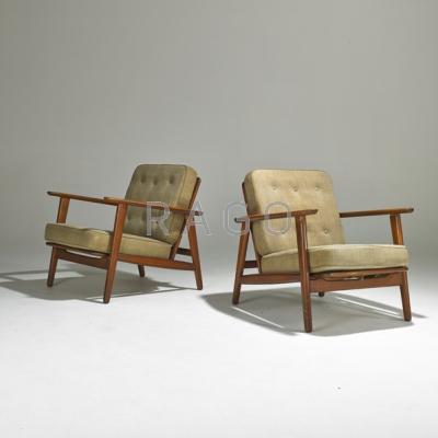 Appraisal: HANS WEGNER Pair of lounge chairs Denmark s Stained beech