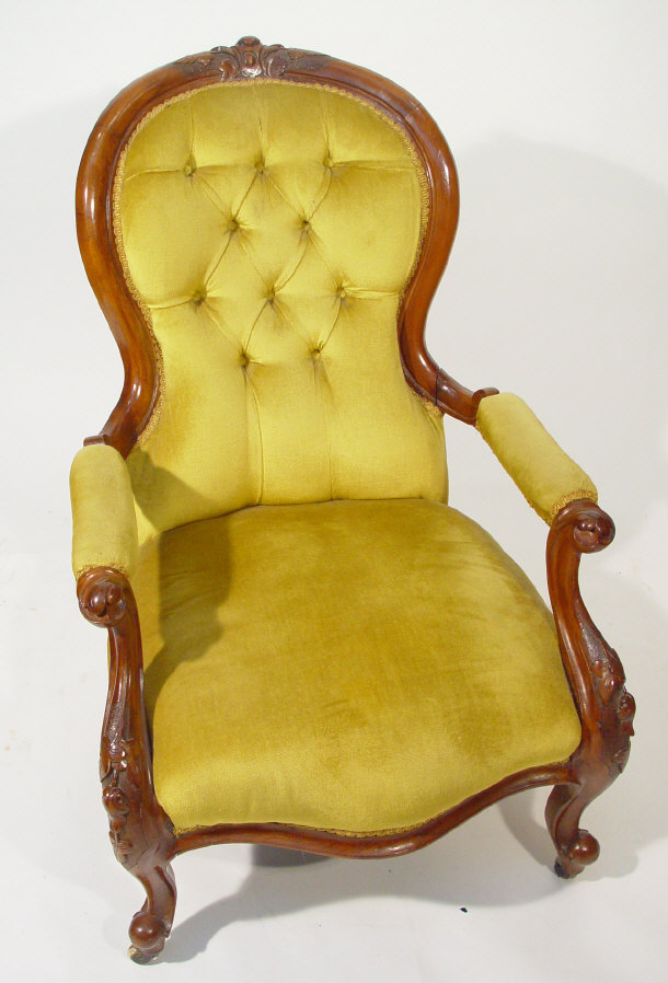 Appraisal: Victorian walnut framed spoonback open armchair with gold buttonback upholstery