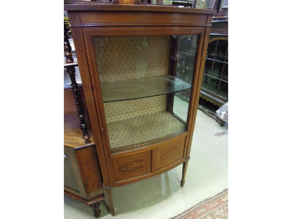 Appraisal: An inlaid Edwardian mahogany bow fronted display cabinet enclosed by