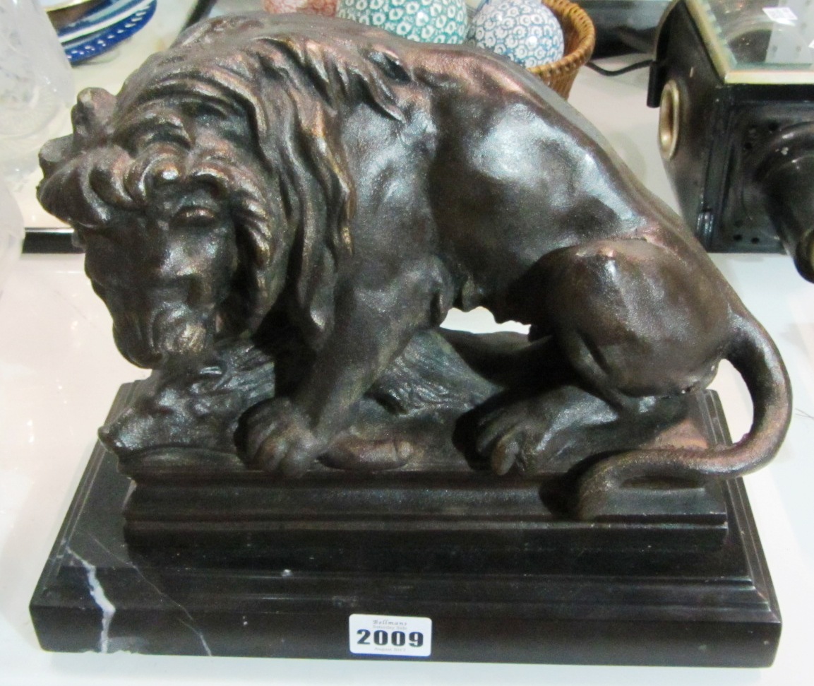 Appraisal: A cast iron figure of a lion on a slate