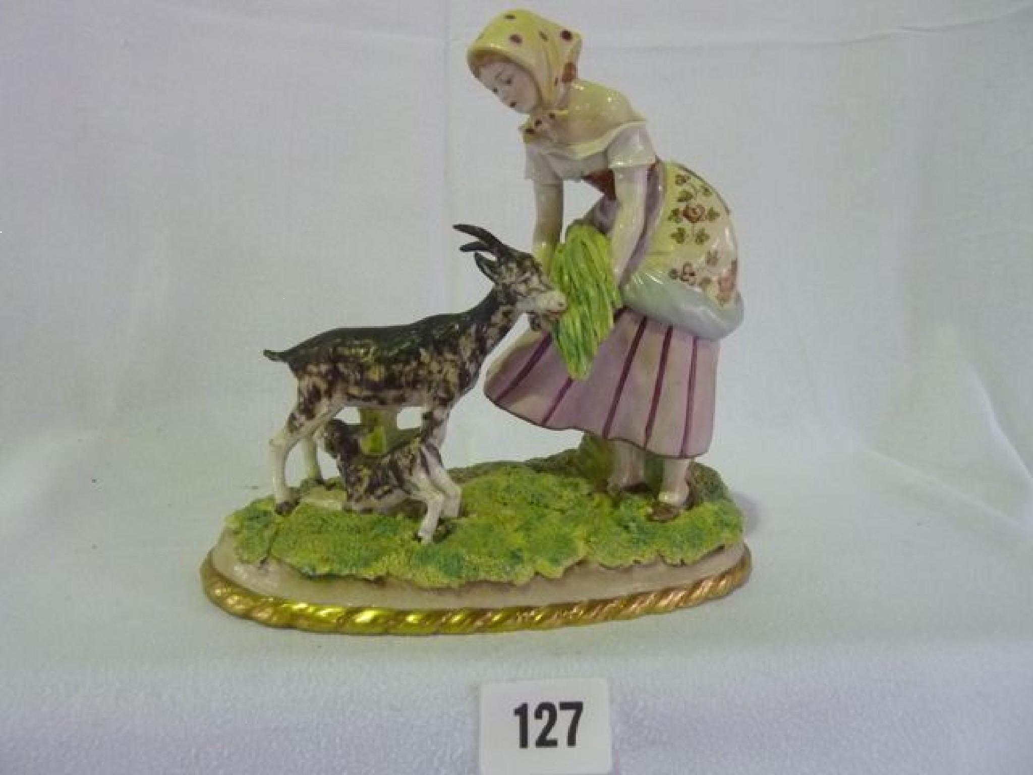 Appraisal: A Sitzendorf figure of a lady feeding goats mounted on