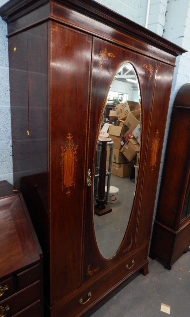 Appraisal: An Edwardian mahogany wardrobe with marquetry panels of urns flowers