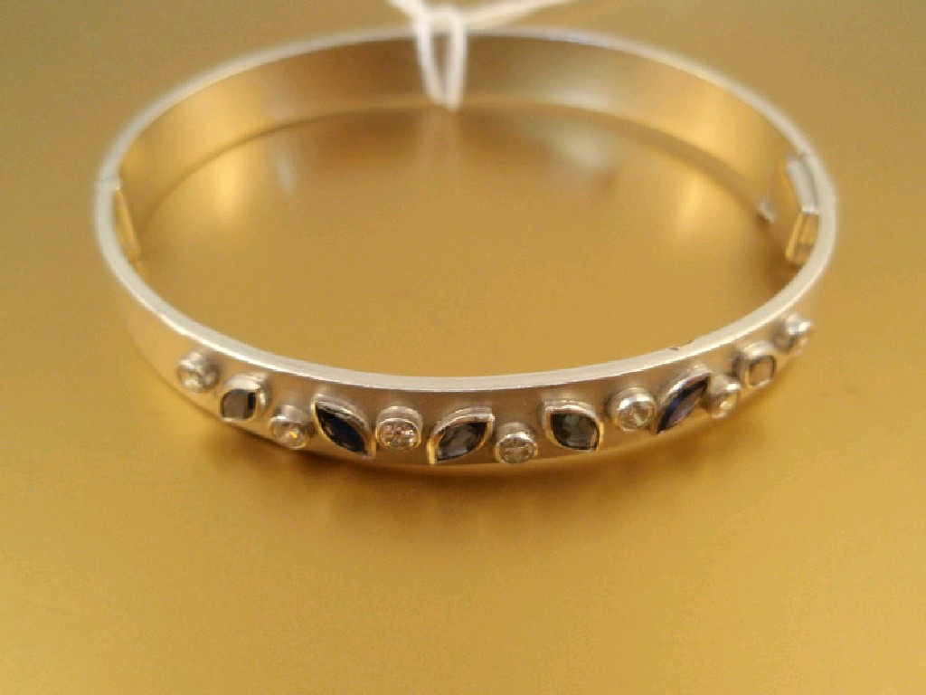 Appraisal: A custom made hinged bangle set with six marquise cut