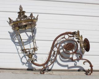 Appraisal: French bronze lantern head mounted on scrolled iron bracket French