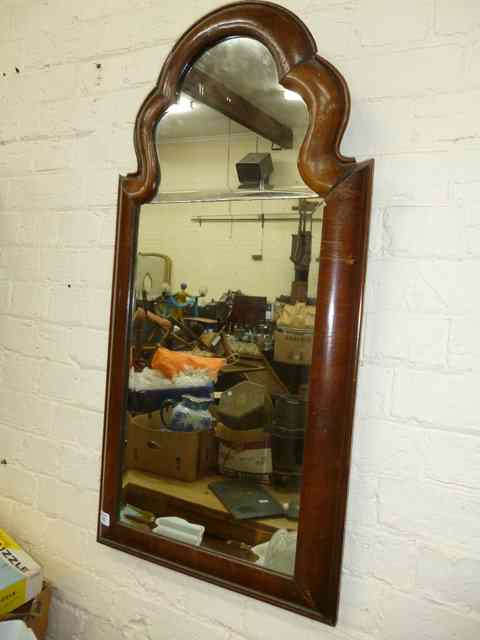 Appraisal: A QUEEN ANNE STYLE WALNUT HANGING WALL MIRROR with serpentine