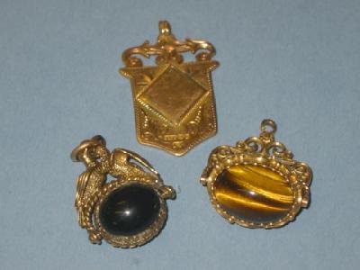 Appraisal: A SWIVEL FOB with cats eye to one side within