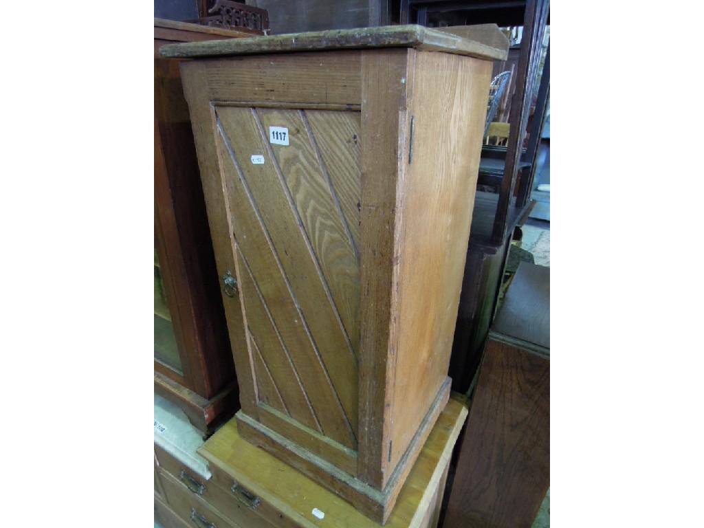 Appraisal: A Victorian ash wood bedside cupboard enclosed by a panelled