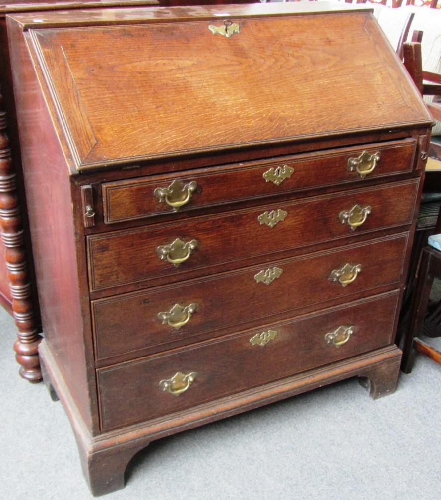 Appraisal: An th century oak bureau the fall enclosing a fitted