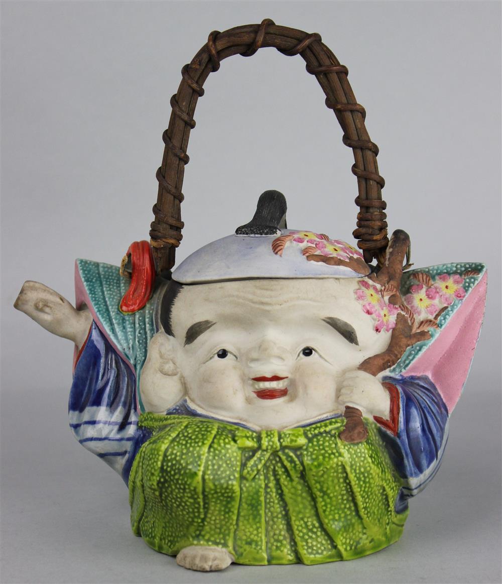 Appraisal: BANKO FIGURAL TEAPOT OF A WHIMSICAL SMILING FIGURE HOLDING A