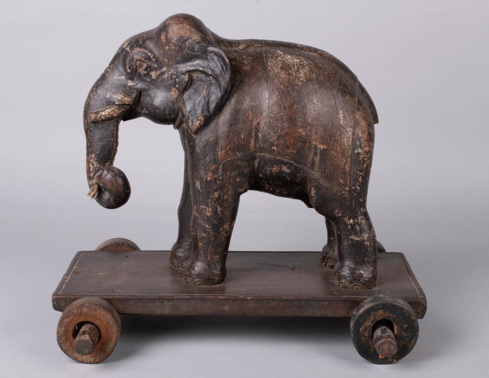 Appraisal: ANTIQUE CARVED ELEPHANT PULL TOY on wooden cart with wooden