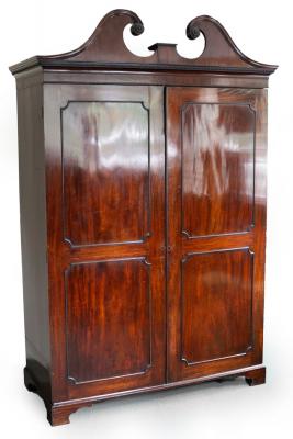 Appraisal: A George III mahogany cupboard the broken swan neck pediment