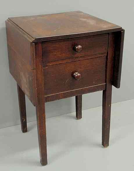 Appraisal: Gustav Stickley two-drawer drop-leaf oak sewing stand with original Craftsman