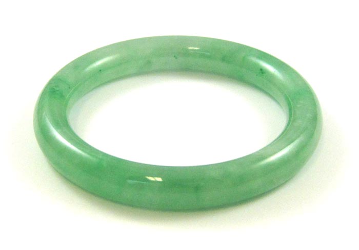 Appraisal: HEAVY GREEN JADE BANGLE The round jade bangle weighs grams