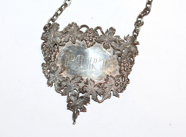 Appraisal: A CONTEMPORARY SILVER DECANTER LABEL cast grapevine decoration in relief