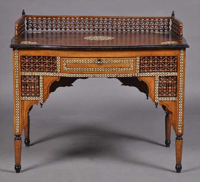 Appraisal: NORTH AFRICAN MOTHER-OF-PEARL AND IVORY INLAID KNEEHOLE DESK The three-quarter