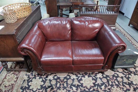 Appraisal: LEATHER SOFA Contemporary red leather on a walnut frame ''