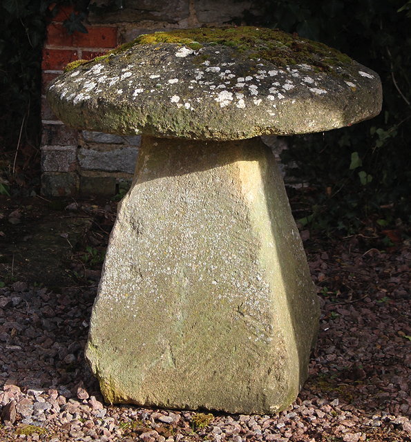 Appraisal: A LARGE OLD CARVED STADDLE STONE the circular top on