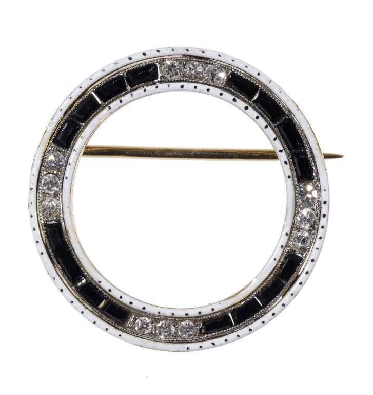 Appraisal: A DIAMOND ONYX GOLD AND WHITE ENAMEL BROOCH in the