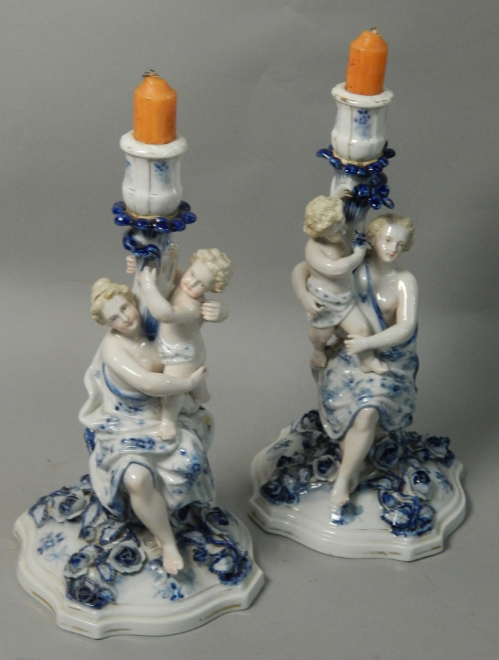 Appraisal: A pair of German Sitzendorf porcelain candlesticks each decorated in