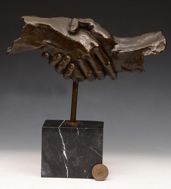 Appraisal: A BRONZE SCULPTURE The Hand Shake on a cubic marble