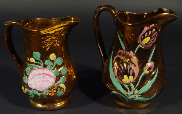 Appraisal: Two graduated Victorian copper lustre jugs each relief moulded and