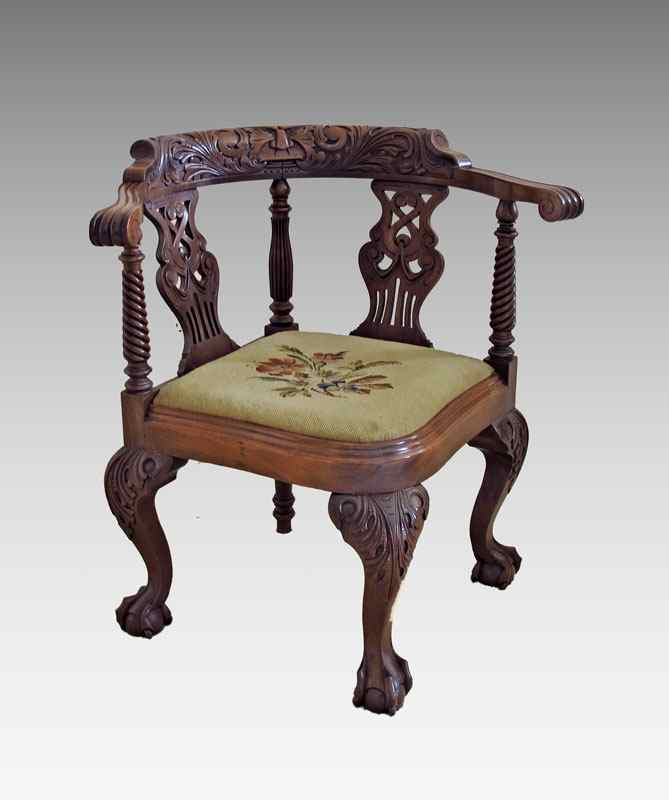 Appraisal: CARVED MAHOGANY CORNER CHAIR Needlepoint seat Northwind carved back ''