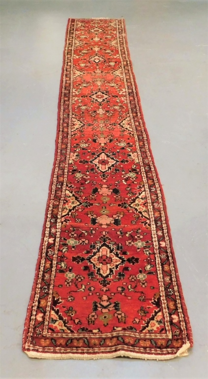 Appraisal: ORIENTAL RUST AND NAVY BOTANICAL CARPET RUNNER Middle East th