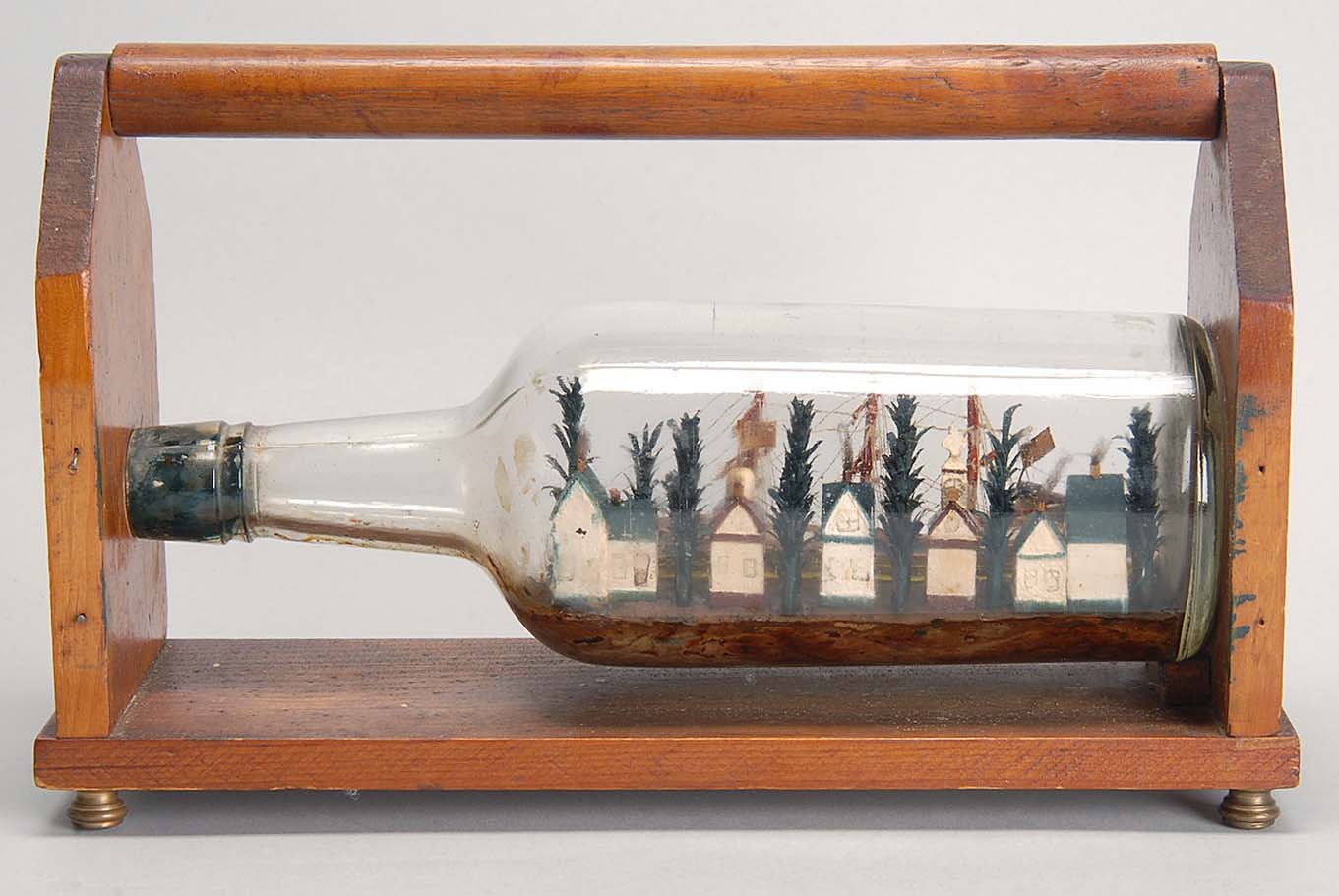 Appraisal: CASED SHIP DIORAMA IN A BOTTLE Three-masted ship with an