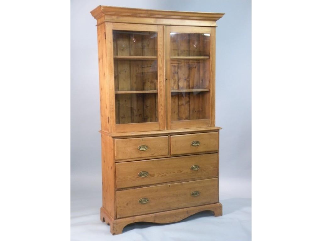 Appraisal: A pine bookcase the top with two glazed doors above