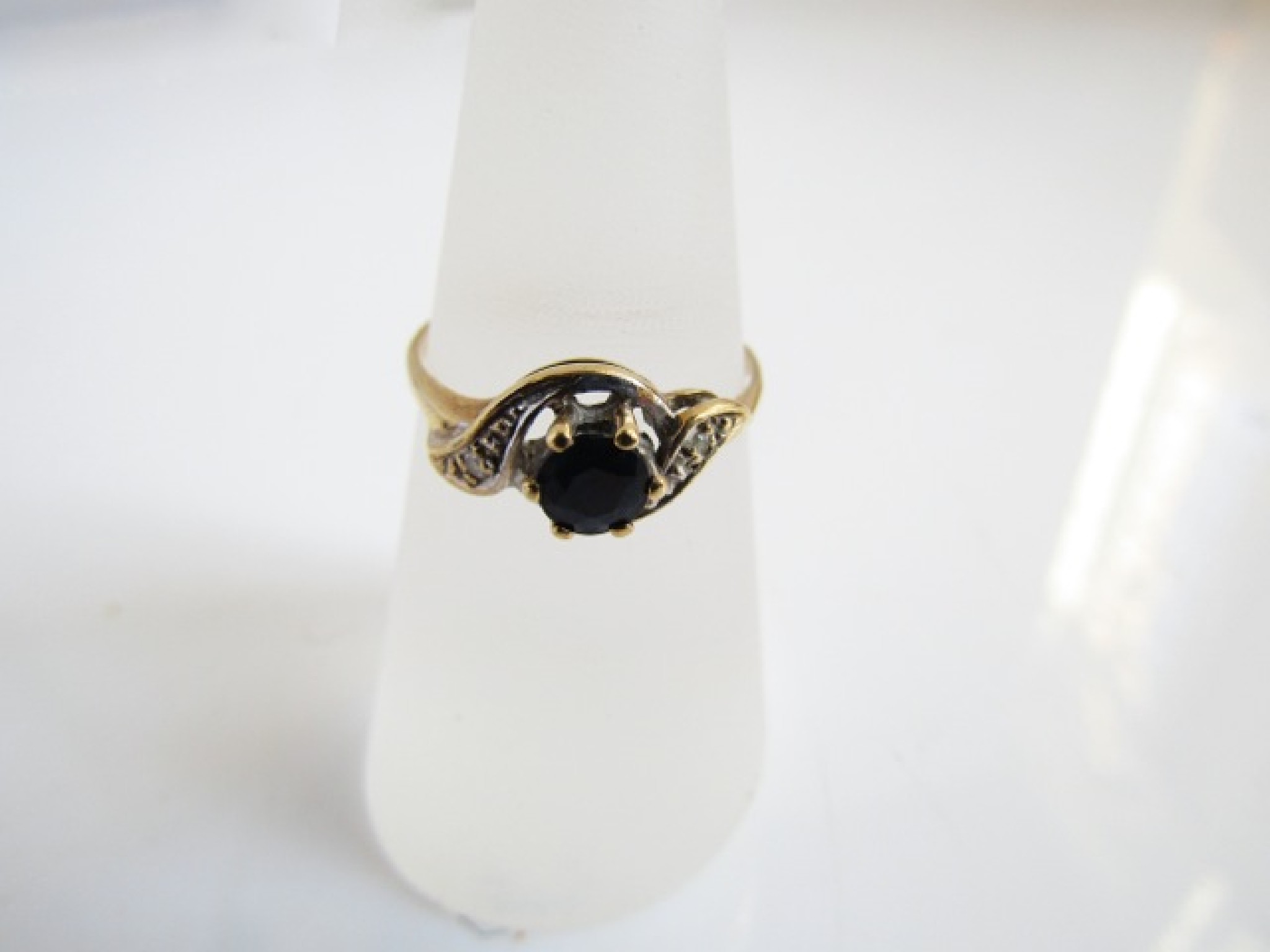 Appraisal: A sapphire and diamond ring centred with a round mixed-cut