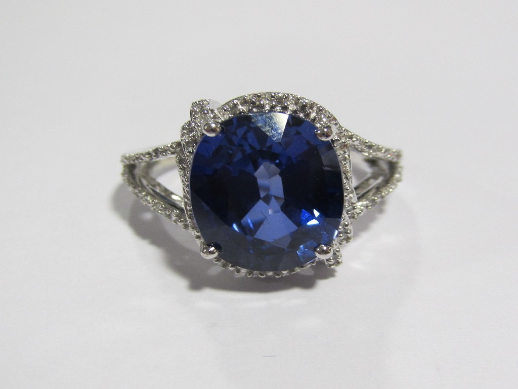 Appraisal: A white gold sapphire and diamond cluster ring with oval