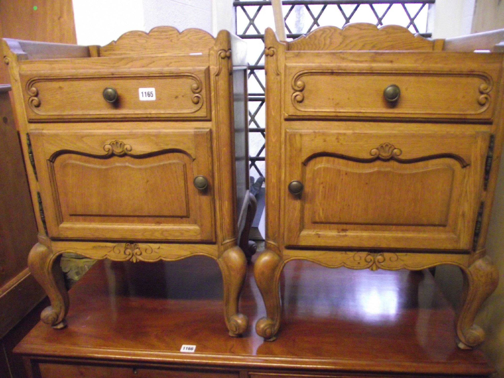 Appraisal: A pair of continental medium to light oak bedside cupboards