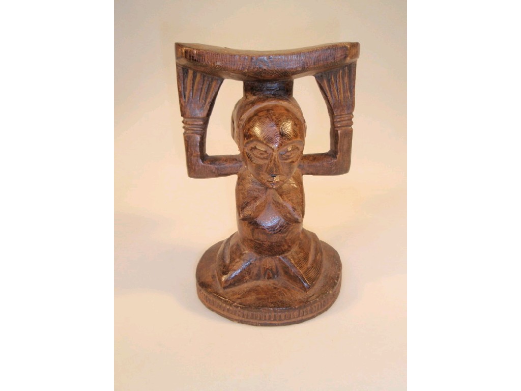 Appraisal: A Luba neckrest modelled as a native African kneeling figure