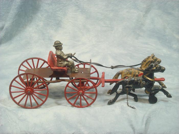 Appraisal: Cast iron toy double horse drawn open carriage cart driver