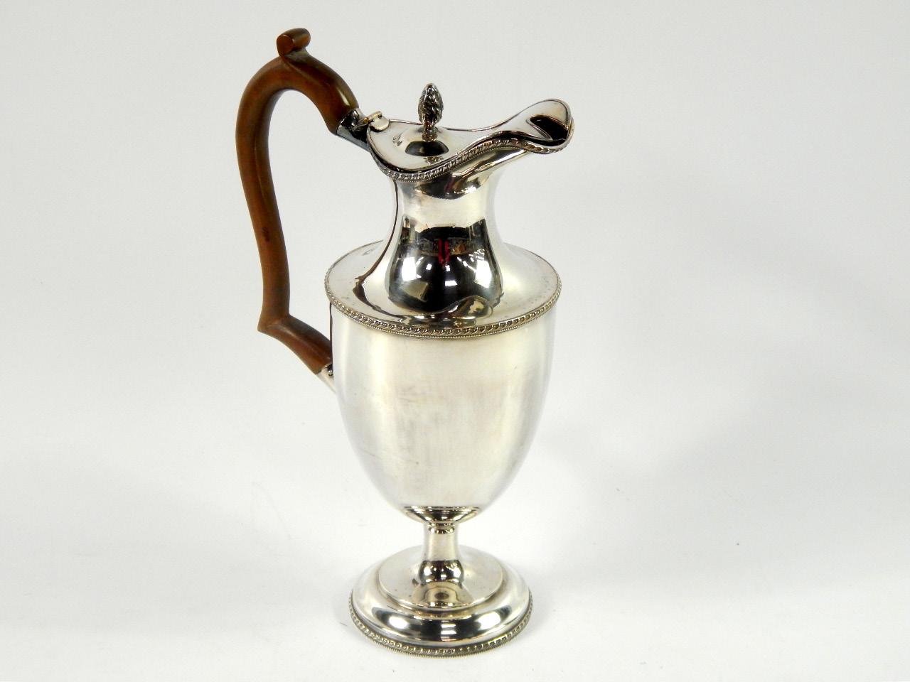 Appraisal: A silver plated claret jug of baluster form with gadrooned