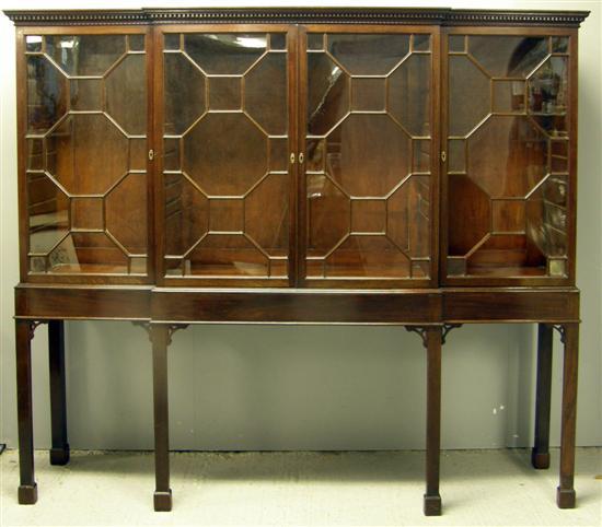 Appraisal: th century mahogany breakfront bookcase on stand with four glazed