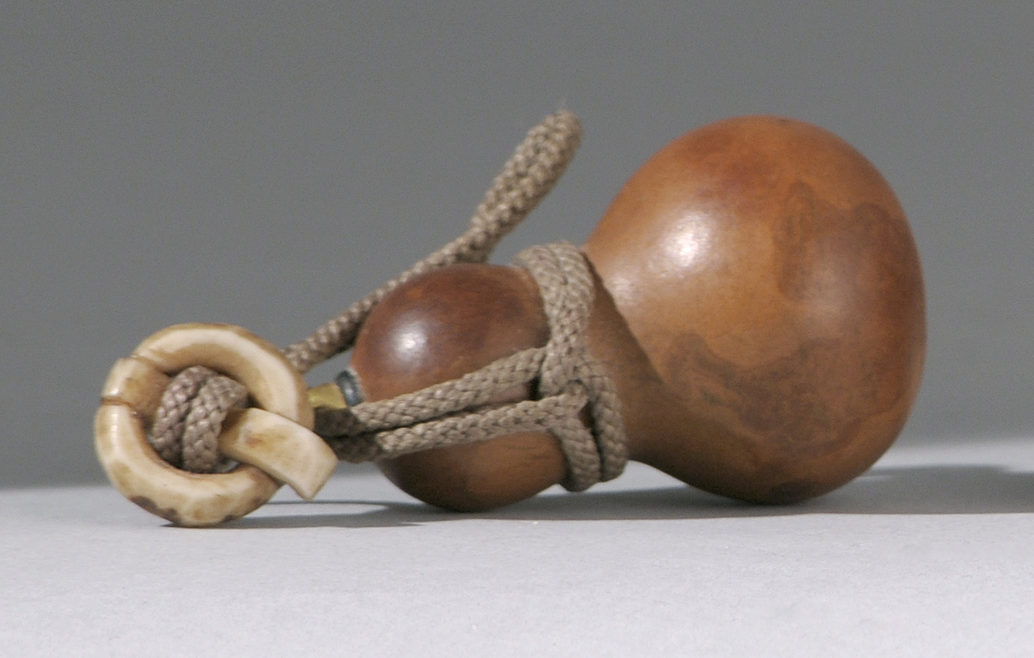 Appraisal: GOURD NETSUKE Meiji PeriodIn double gourd form with a gold