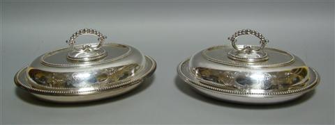 Appraisal: PAIR OF SILVER PLATED COVERED SERVING DISHES Of oval form