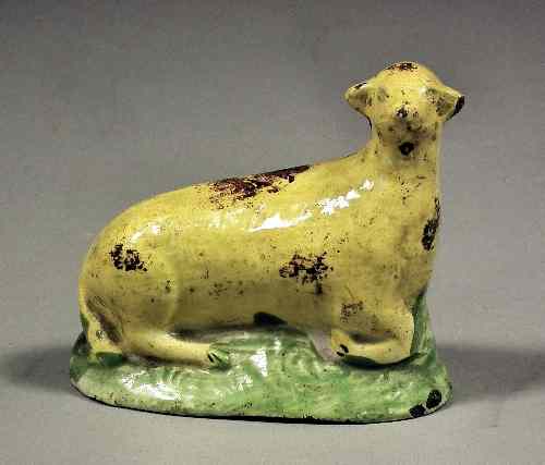 Appraisal: A small early Staffordshire pottery figure of a recumbent yellow